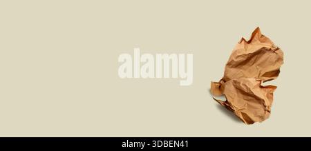 Brown paper, paper scrap, isolated. Modern abstract artistic image. Sustainable packaging, sustainable use of materials, crumpled used paper Stock Photo
