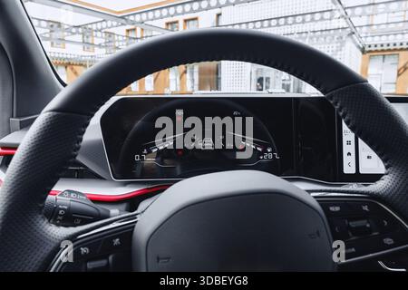 High-tech car dashboard displaying navigation and vehicle information in a modern setting Stock Photo