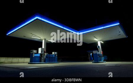 Gas station with blue neon lights on the road side, night photography Stock Photo