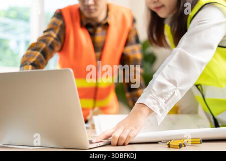 Engineers team and owner discuss check and review the laptop of construction. Contractor inspection drawing before start project civil. project planni Stock Photo