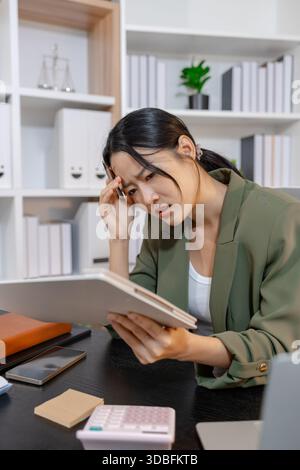 Stressed businesswoman dealing with heavy work pressure, reacting emotionally while reviewing reports and facing tight deadlines, highlighting workpla Stock Photo