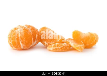 Whole and sliced tangerines with green leaf on black background mandarin orange Stock Photo