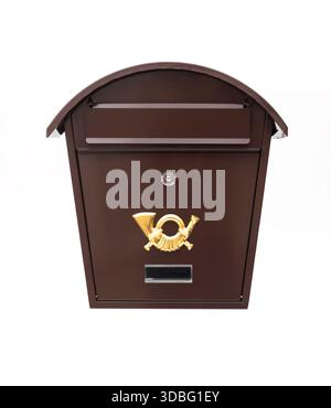 Vintage brown metal mailbox with a golden post horn emblem and curved roof, isolated on a white background Stock Photo
