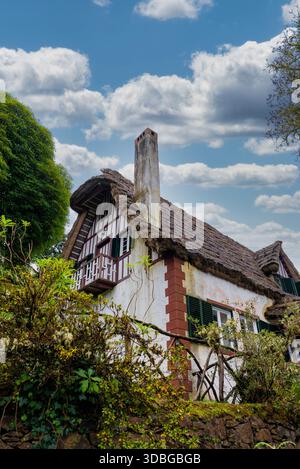 Thatched cottage and chimney in Funchal, Portugal, low angle view Stock Photo