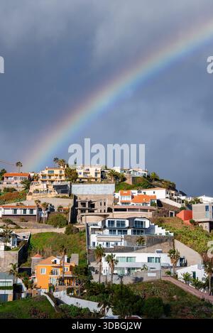 Rainbow over terraced homes in Funchal, Madeira, Portugal Stock Photo