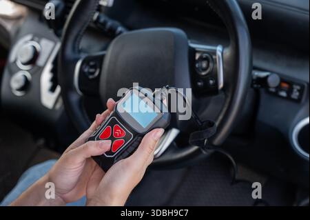 Woman using OBD2 diagnostic scanner.  Stock Photo