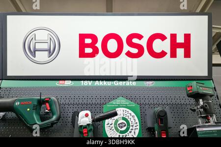 Kiel, Germany - 15. December 2025: Bosch brand logo displayed above a retail shelf showcasing various power tools Stock Photo