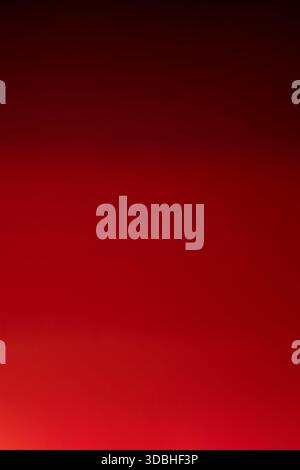 Simple red gradient background transitioning from light to dark shades, ideal for festive designs, ads, or holiday cards. Stock Photo