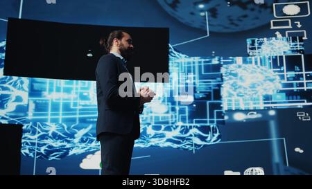 Entrepreneur presenter hosting live conference to highlight AI usage in business growth, demonstrating the use of neural networks system and machine learning. Fintech event. Camera B. Stock Photo