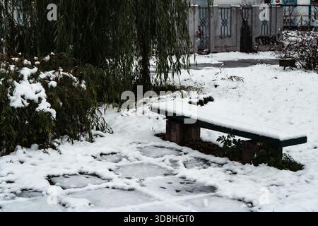 there is a bench in the snowy park. High quality photo Stock Photo