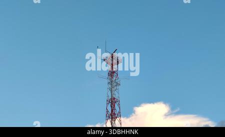 Telecommunication Tower with Antennas Against Clear Blue Sky Stock Photo