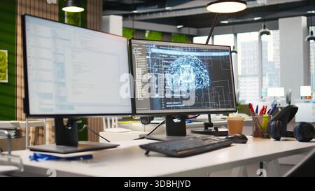 PC in empty IT startup office displaying artificial intelligence programming languages used for building applications. Computer showing machine learning code in software development agency Stock Photo