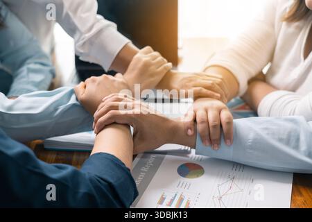 Professional businessman led the team meeting, In the corporate office, emphasizing the importance of teamwork in their business work alongside his co Stock Photo