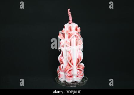 Handcrafted carved candle made from layered white and pink wax Stock Photo