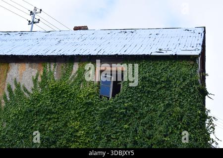 old half-timbered house with snow on the roof and open windows Stock Photo
