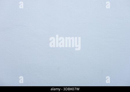 A plain white textured background with subtle variations in tone. Ideal for use in design and artistic projects. Stock Photo