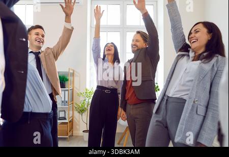 Happy excited business people celebrating success in business or making a deal in office Stock Photo