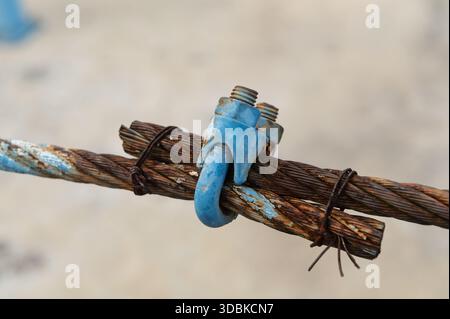 Old steel wire rope clamp for tightening sling Stock Photo