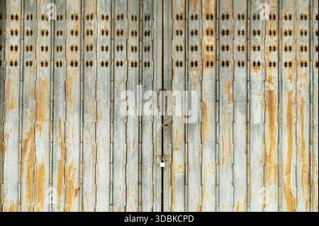 Vintage rusty folding door with star pattern cutouts Stock Photo