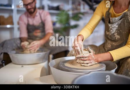 Group of People hands shaping pottery from wet clay. Creative, hobby ,workshop  concept Stock Photo