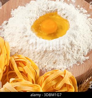 Italian pasta tagliatelle homemade on wooden table Stock Photo