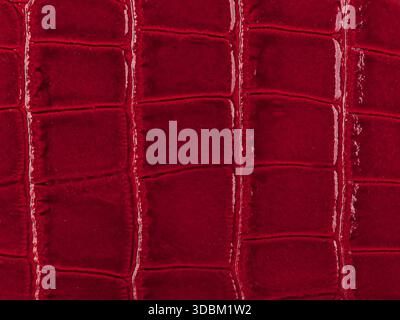 Abstract texture of synthetic leather, red background. Stock Photo