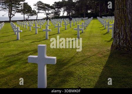 People walk among gravestones at the American Cemetery, Omaha Beach, Normandy, France Stock Photo