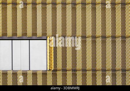Melodic Metalwork: Interplay of Pattern and Light. The facade of the Ecole des Cropettes in Geneva, Switzerland combines expanded metal mesh with minimalist aluminum windows, designed by LVPH architectes Sarl. The renovation from 2014n2015 created a double skin that shifts with the light, balancing aesthetics and function in an innovative educational space. Stock Photo