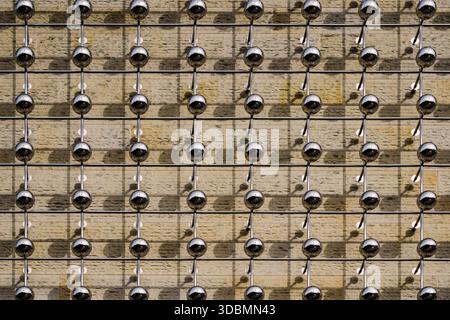 Münster, Germany, facade of the LWL Museum of Art and Culture with the installation 'Silver Frequency' by Otto Piene, featuring rows of metallic spheres mounted on the wall Stock Photo