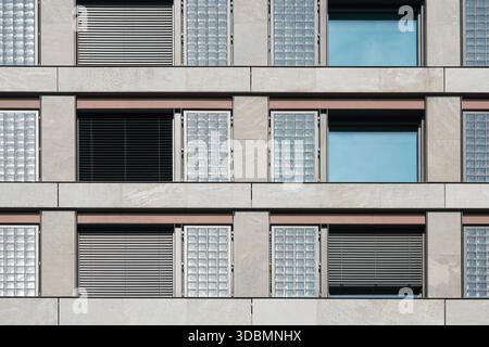 Zurich, Switzerland, commercial facade, modern building, glass block windows, horizontal blinds, repetition, symmetry, texture, grid design, open window blinds, asymmetry, frosted glass Stock Photo