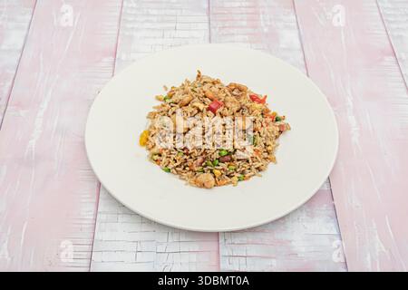 Seafood chaufa, a colorful dish with a variety of seafood such as prawns, squid, and scallops, stir-fried with rice, egg, bell peppers, and scallions Stock Photo