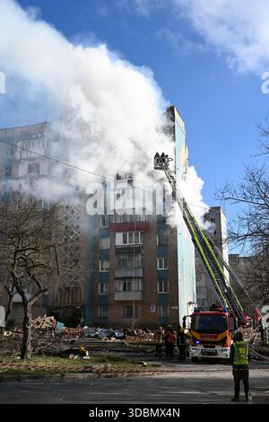 Ternopil, Ukraine - November 19, 2025: Rescue personnel battle a blaze in a heavily damaged apartment building following Russian air missile strike in Stock Photo