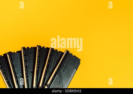 Fan arrangement of DDR RAM modules on yellow background with copy space Stock Photo