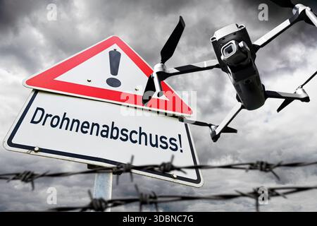Drone in the sky and danger sign with the inscription Drone launch, symbolic photo Drone overflights and drone defense, photomontage Stock Photo