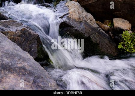 water pours over the earthstones. small stream Stock Photo