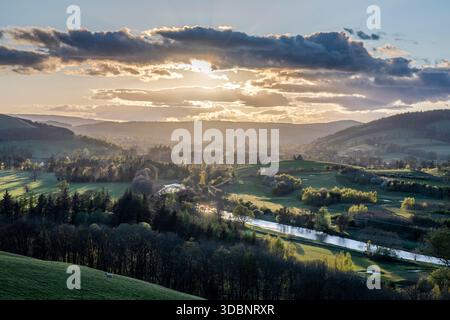 Golden sunset over the Weed Valley landscape, river winding through green hills and trees near Horsburgh Castle. Stock Photo
