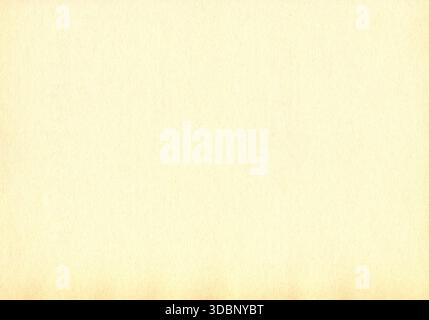 Surface of old paper or cardboard, background, texture. Backdrop of yellowed, aged paper surface. Worn out yellowed paper piece. Shabby ancient wall Stock Photo