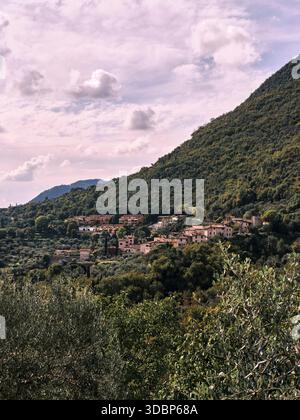 Mountain village in Italy on Lake Garda near Toscolano Maderno. It's a sunny summer's day with a slightly cloudy sky. Typical local flora is in bloom. Stock Photo