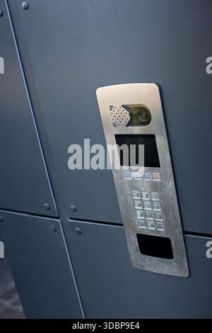 Keypad and camera on a section of wall Stock Photo
