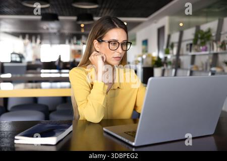 Focused young project manager working on online business project Stock Photo