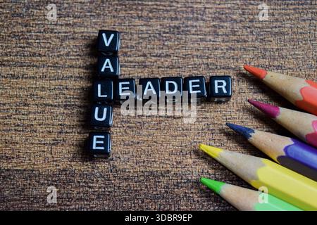 Concept of value and leader words arranged with on wooden letter blocks. Stock Photo