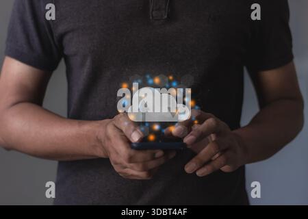Young man with smartphone mobile hand touching to cloud computing diagram, Data storage, Cloud technology, Cloud Computing Storage Stock Photo