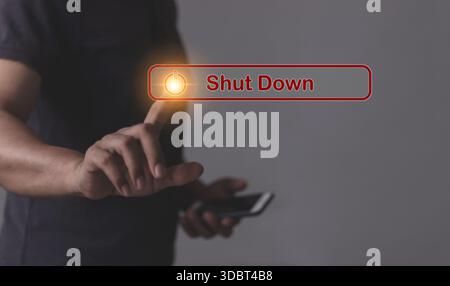 Young man with smartphone hand touching Shut Down button press power OFF Stock Photo