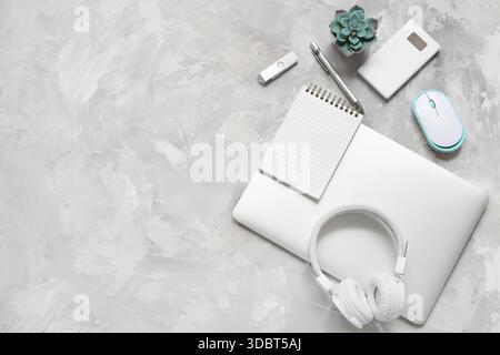 Modern gadgets with notebook on grunge background Stock Photo