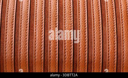 Striped brown leather texture with visible grain and stitching in natural warm tones. Natural background ideal for fashion, upholstery, bags Stock Photo