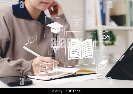 Online education and e-learning concept. Woman use tablet with icons representing online education, learning, knowledge sharing, educational tools, tr Stock Photo
