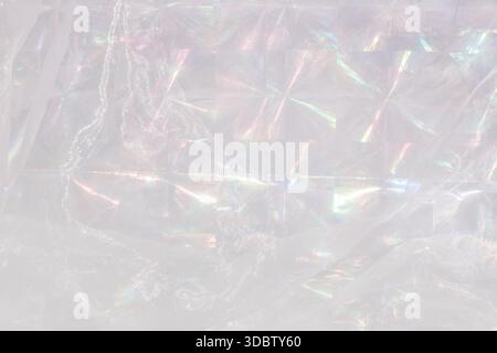 Abstract background made of holographic white fabric with iridescent prisms and subtle ripples. Luminous and reflective texture, changing light spectr Stock Photo