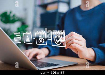 Business process planning and task management timeline. Person working on laptop with interface showing sequential calendar process with icons for sch Stock Photo