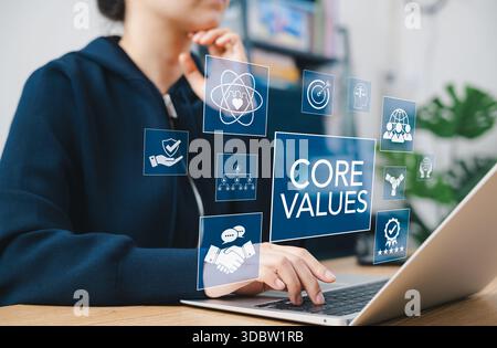 Business core values and corporate culture concept. Person using laptop with core values icons, ethics, teamwork, integrity, corporate mission, Stock Photo