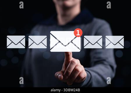 New email notification interaction concept. A woman interacting with a digital interface showing a new email notification symbol, a concept for online Stock Photo